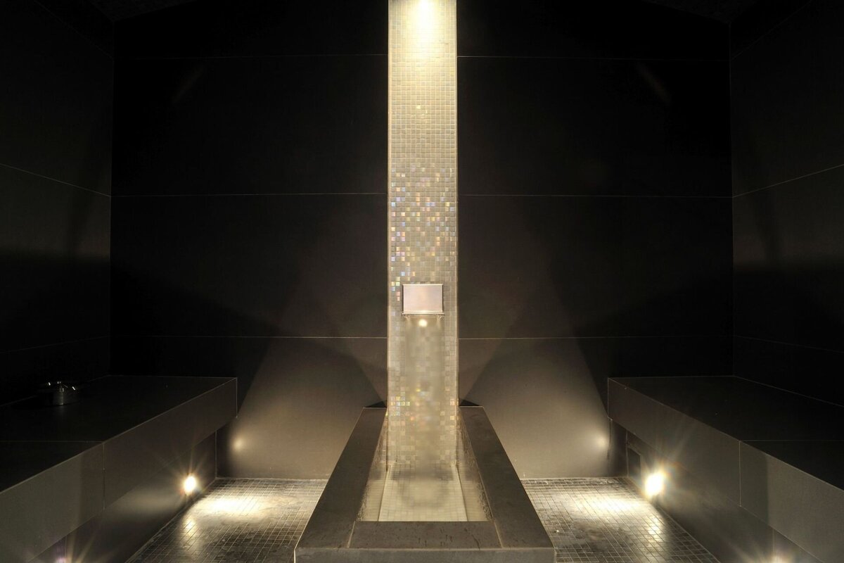 A dark room with a few lights on the floor