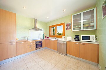 A kitchen with stainless steel appliances and wooden cabinets