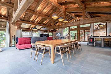 A living room with a wooden table and chairs
