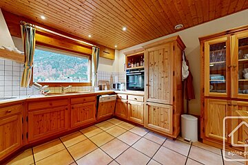 A kitchen with wooden cabinets and a sign that says alpine property