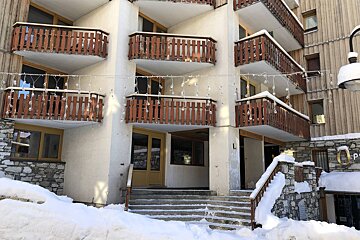 A building with balconies and a sign that says l on it