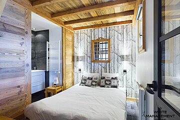 A bedroom with white management written on the door