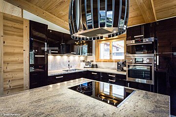 A kitchen with black cabinets and a stove top oven
