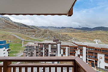 A balcony with a view of mountains and a building that says ' montagne ' on it