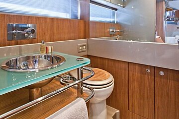 A bathroom with a toilet a sink and a mirror