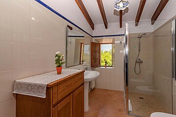 A bathroom with a sink and a walk in shower