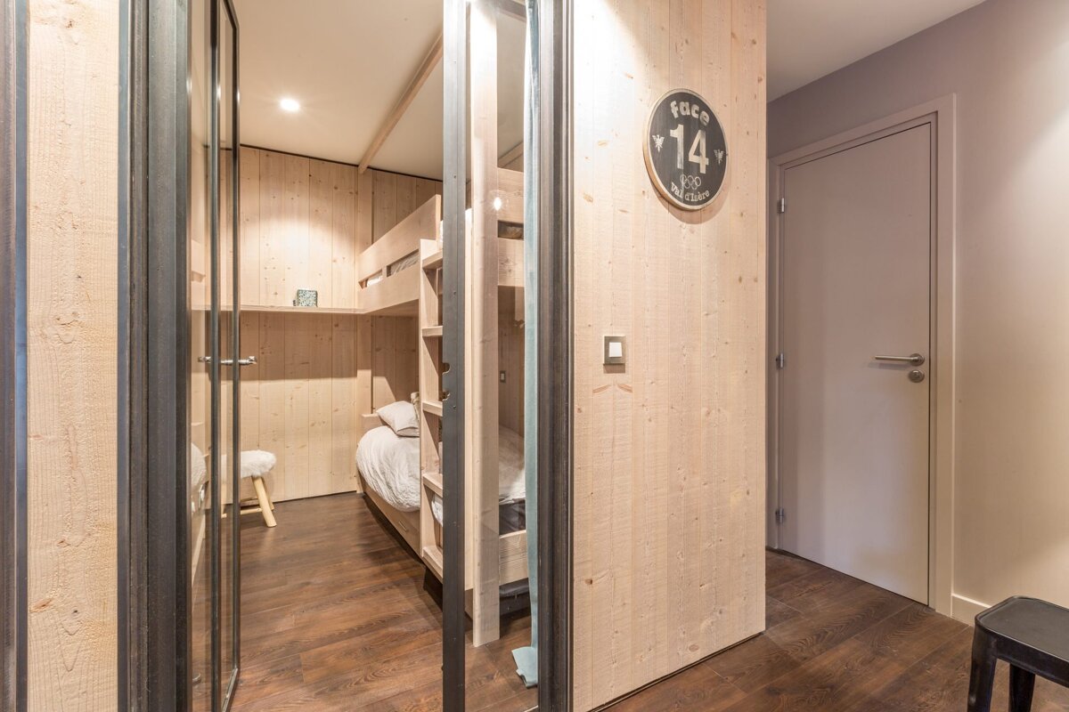 A snowy mountain with a building in the foreground