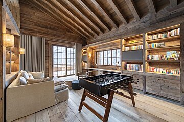 A living room with a couch and a foosball table