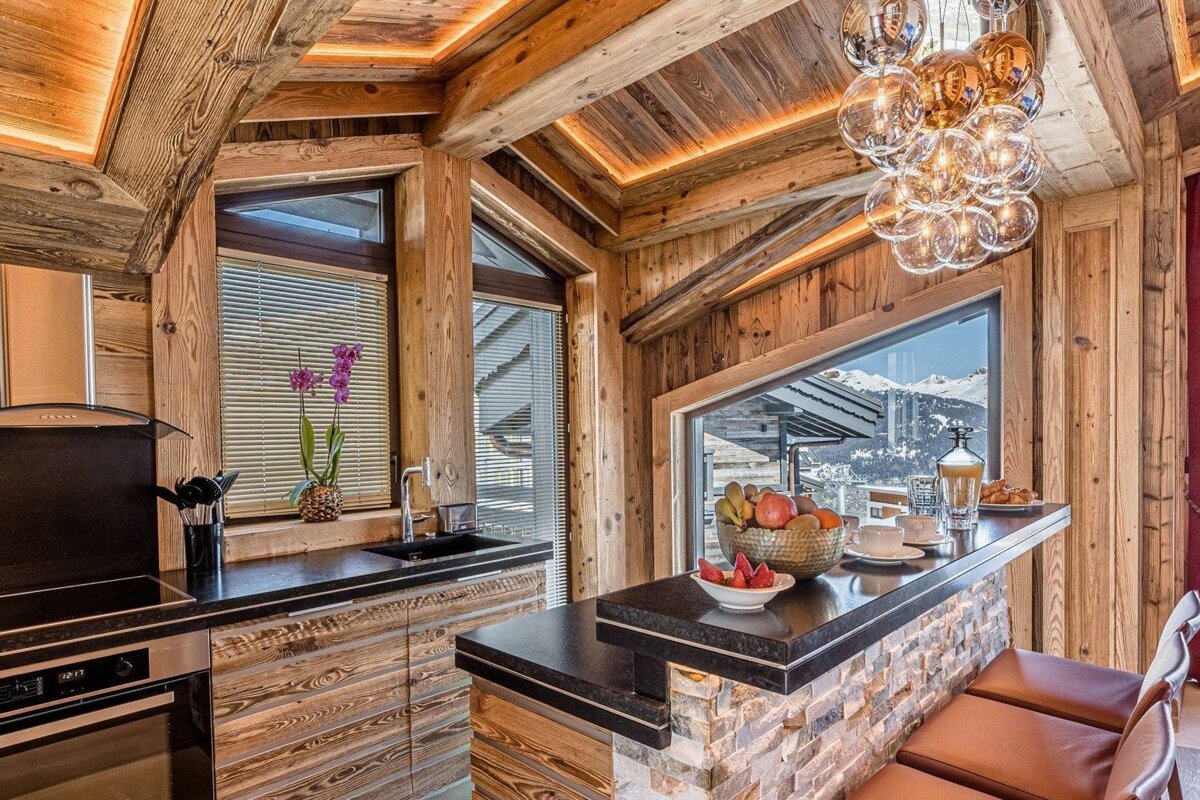 A kitchen with a bowl of fruit on the counter