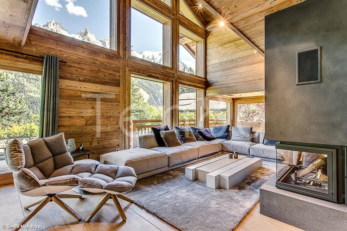 A living room with a large couch and a fireplace