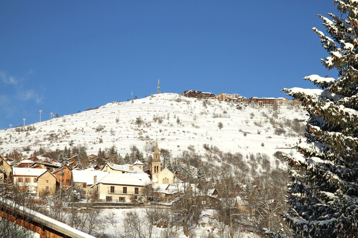 A snowy mountain with a church on top of it