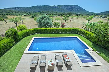 A swimming pool with a mountain in the background