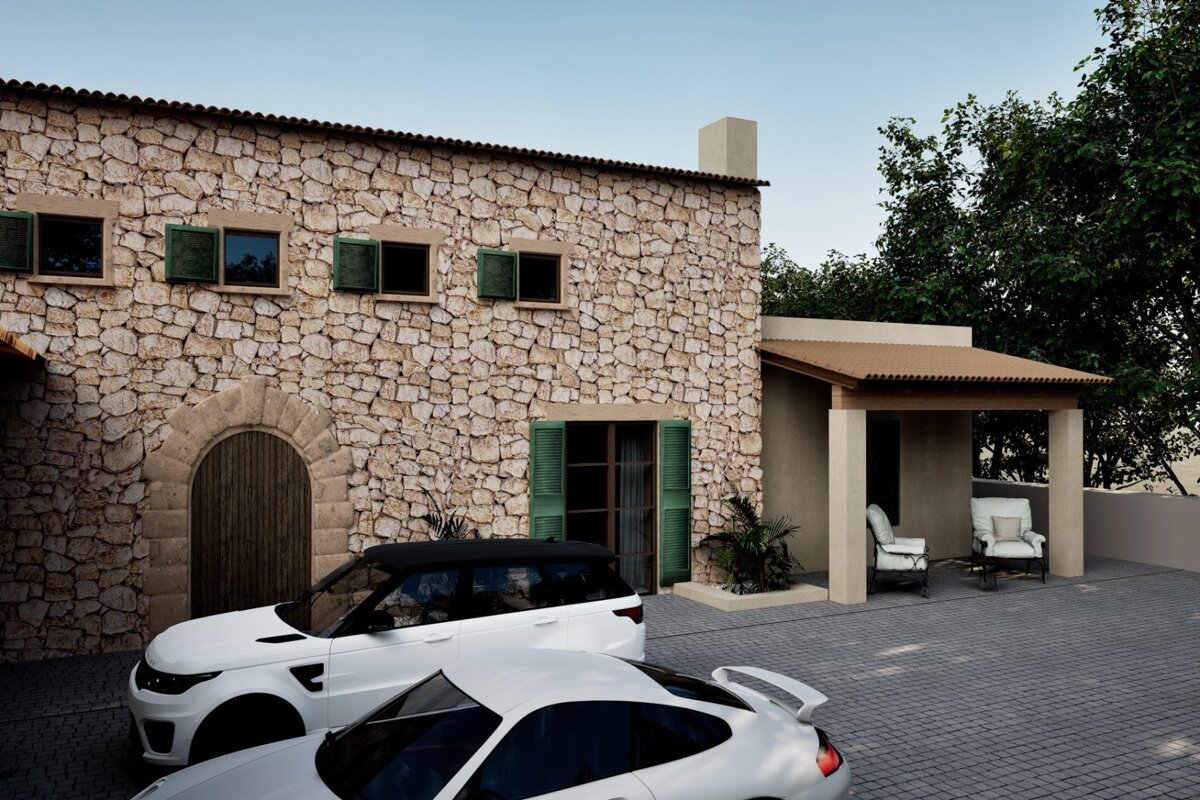 A white car is parked in front of a stone building