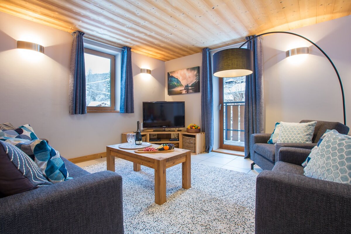 A living room with two couches and a flat screen tv
