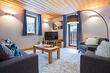 A living room with two couches and a flat screen tv