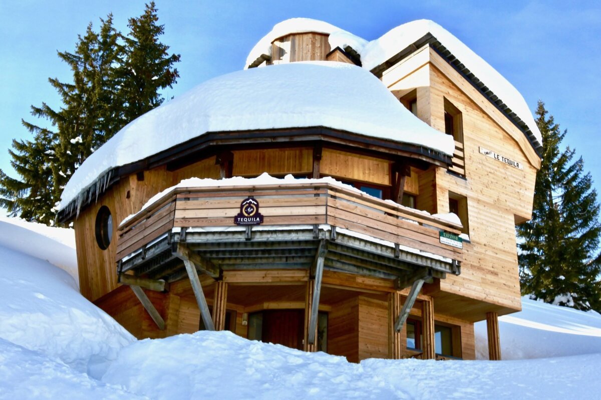 A snow-covered wooden chalet, 