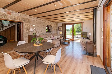 A living room with a table and chairs and a fireplace
