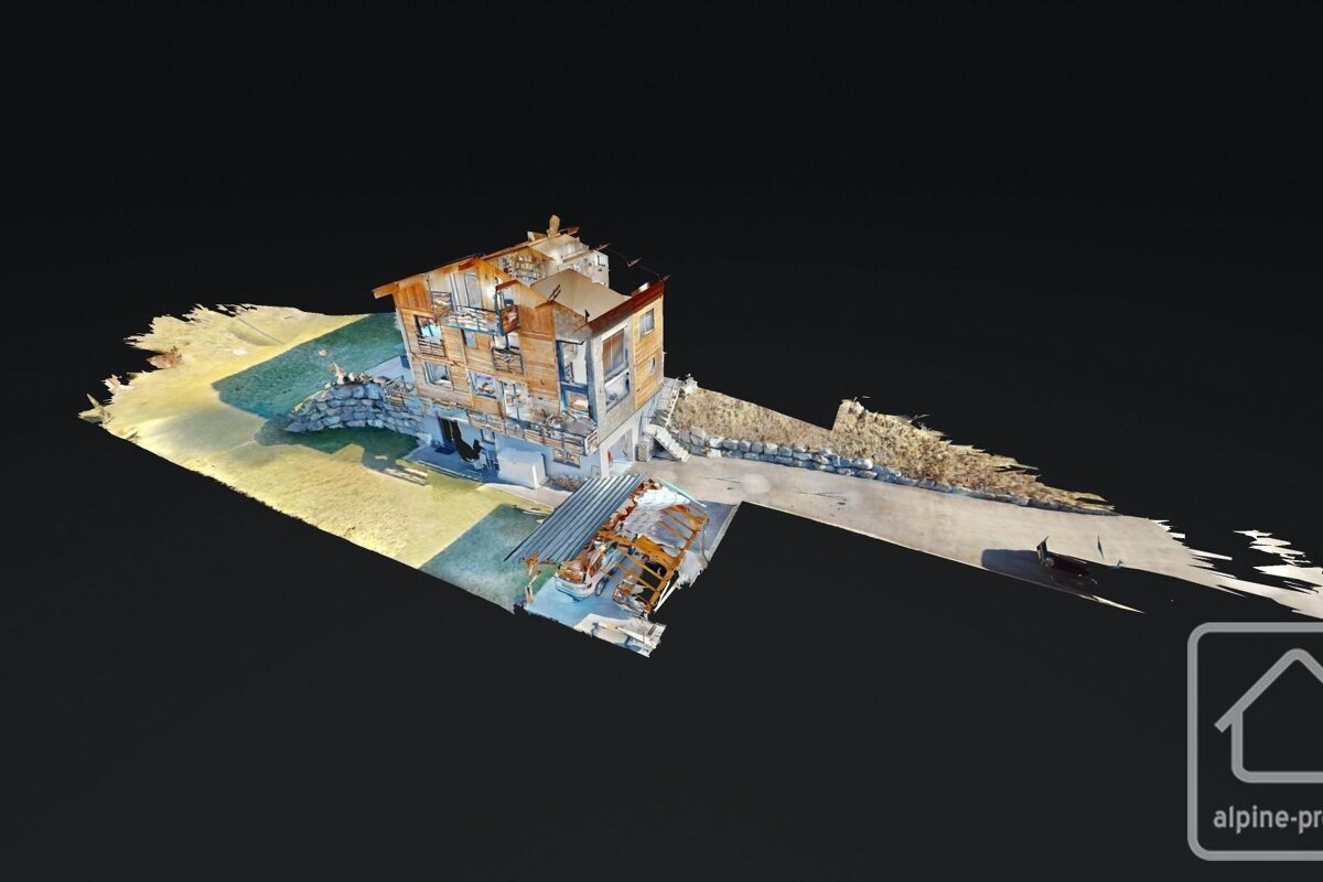 3D scan of a wooden chalet with balconies on a patchy landscape, against a dark background.
