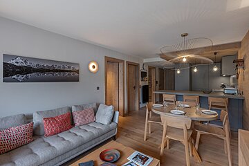 A living room with a couch and a dining table