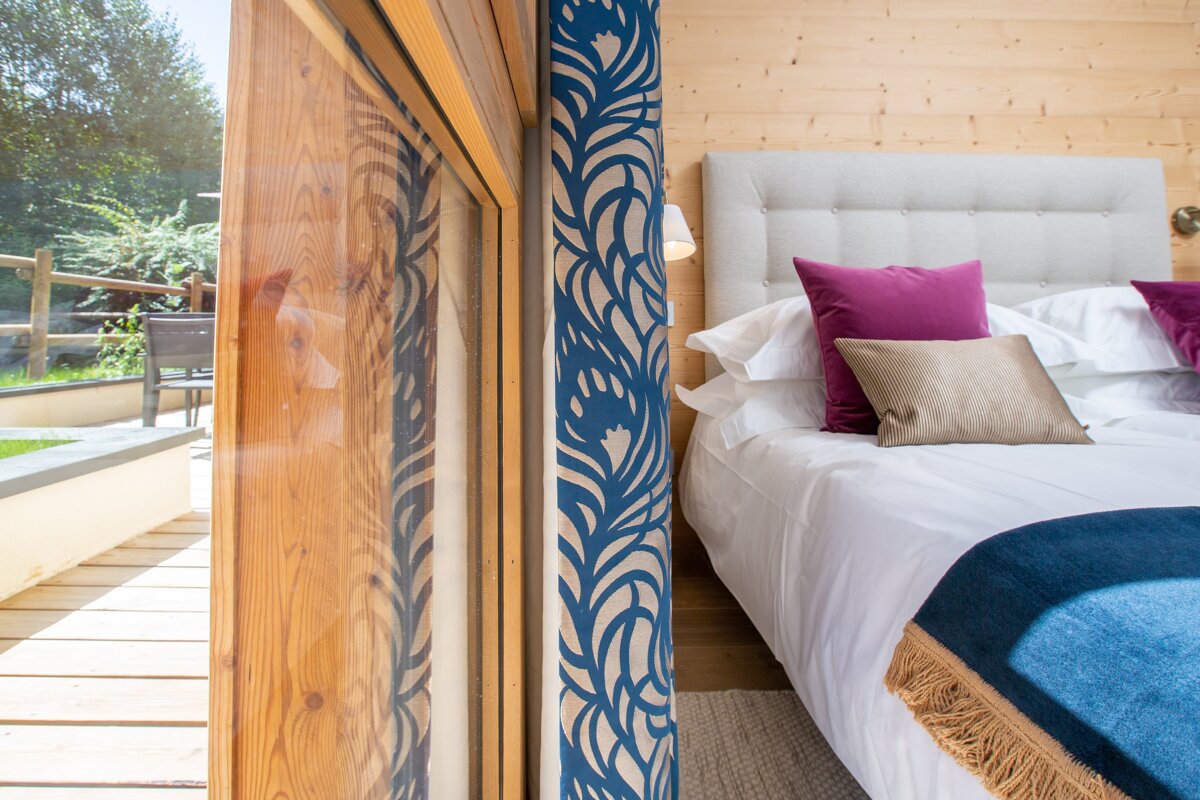 A bedroom with a bed and a sliding glass door