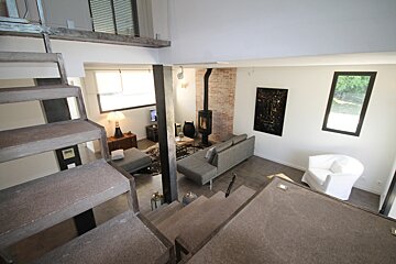 A living room with stairs leading up to the second floor