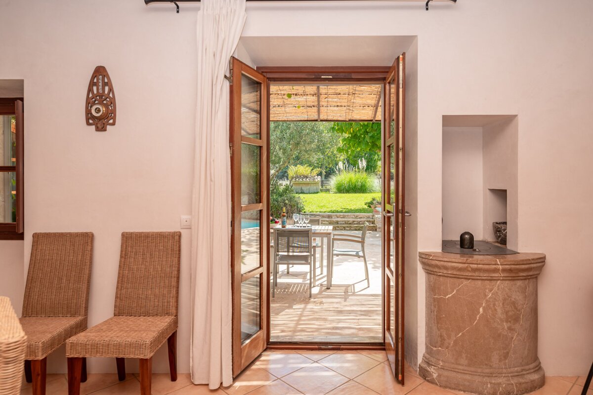 A door open to a patio with a table and chairs