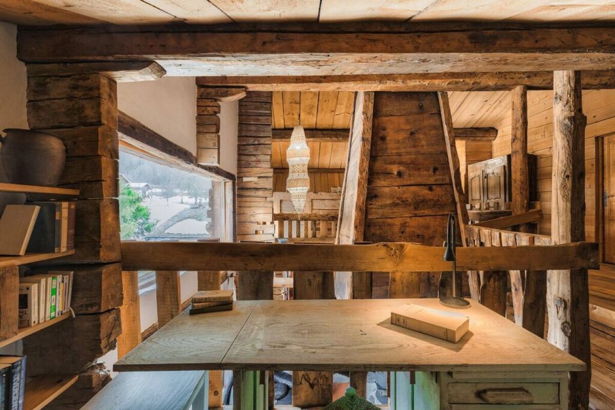 A wooden desk with a book on top of it