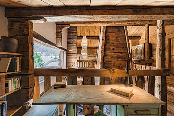 A wooden desk with a book on top of it