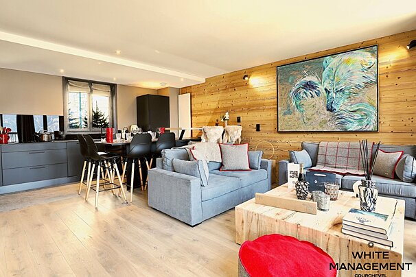 A living room with a rental designer logo on the bottom