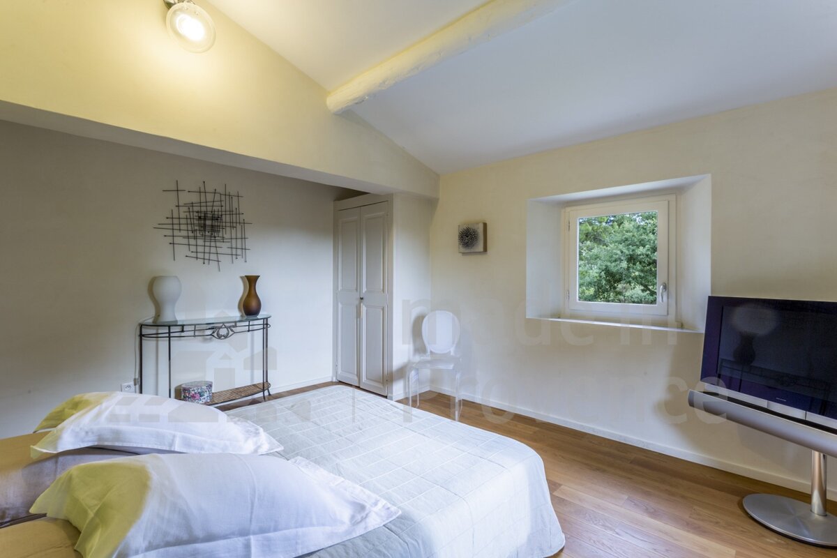 A bedroom with a large bed and a flat screen tv