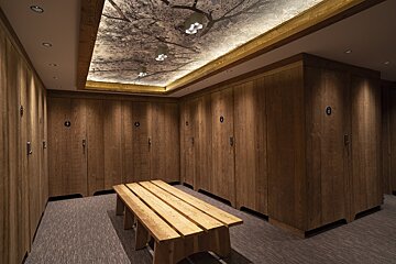 A locker room with wooden cabinets and a wooden bench