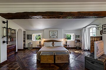 A bedroom with a bed and a flat screen tv
