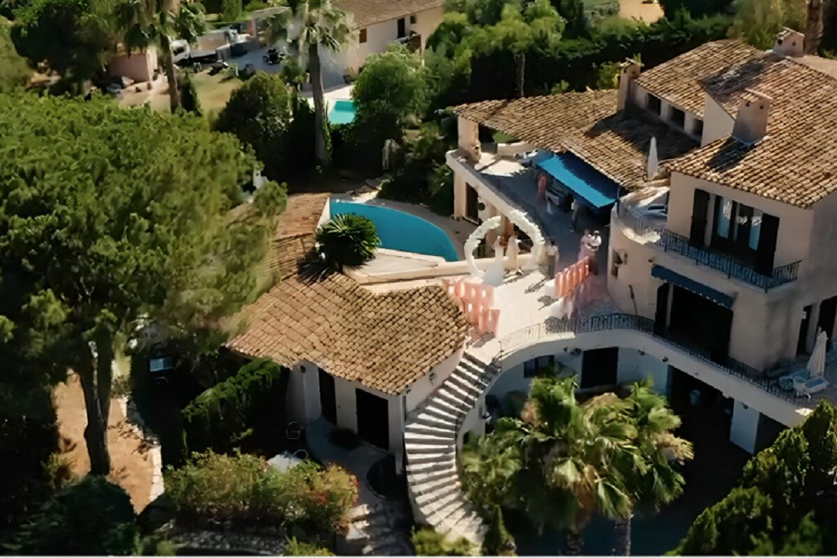 An aerial view of a large house with a pool
