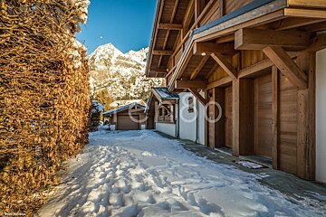 A snowy path leading to a house with the word rentoo on the side