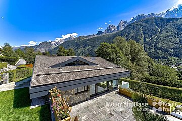 A house with mountains in the background is for sale by mountain base