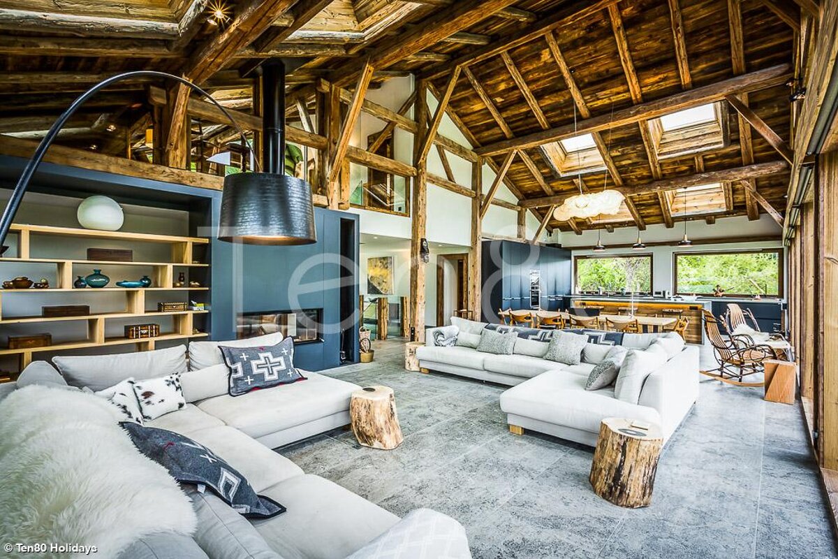 A living room with a couch that has a pillow with a cross on it