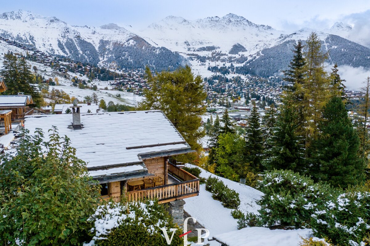 An aerial view of a snowy mountain landscape with the letter vb in the foreground