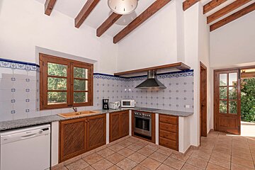 A kitchen with stainless steel appliances and wooden cabinets