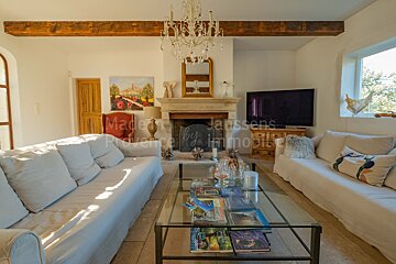 A living room with a couch and a glass coffee table