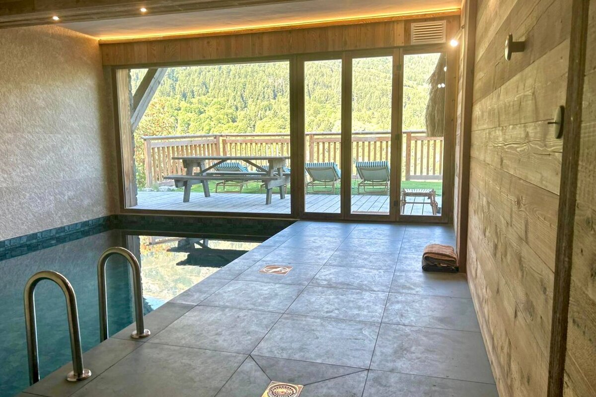 A swimming pool with a view of a deck and mountains