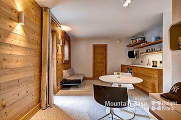 A room with a table and chairs and a sign that says mountain base