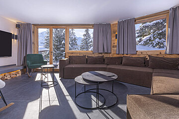 A living room with a couch and two tables