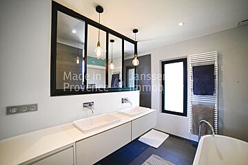 A bathroom with two sinks and a window that says made in provence