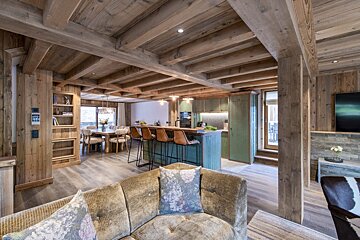 A living room with a couch and a floral pillow