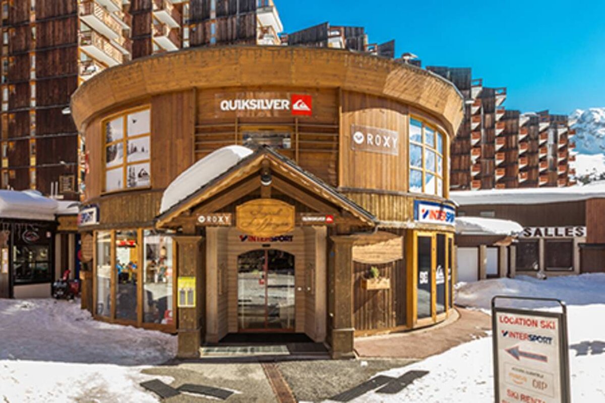 A quiksilver store is surrounded by snow