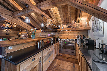 A kitchen with stainless steel appliances and wooden cabinets