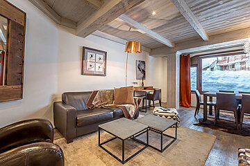 A living room with a couch and two coffee tables