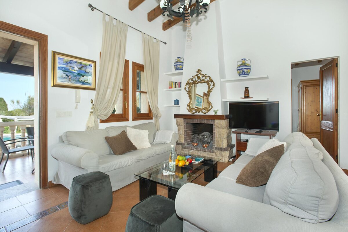A living room with a fireplace and a flat screen tv
