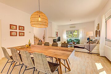 A living room with a wooden table and chairs