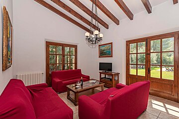 A living room with red furniture and a flat screen tv